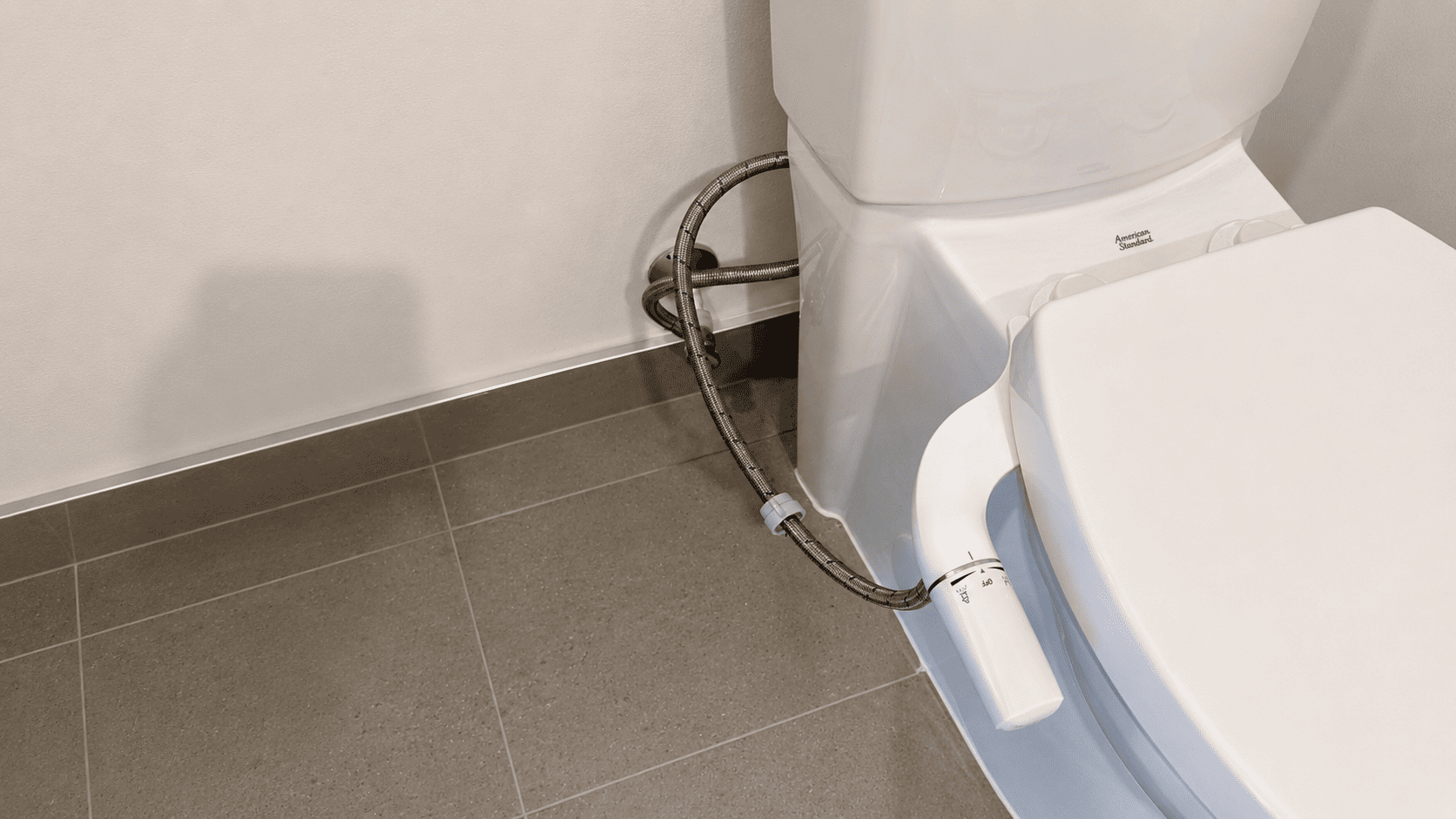Licensed plumber installing a bidet seat in a Toronto bathroom — Torr Handyman