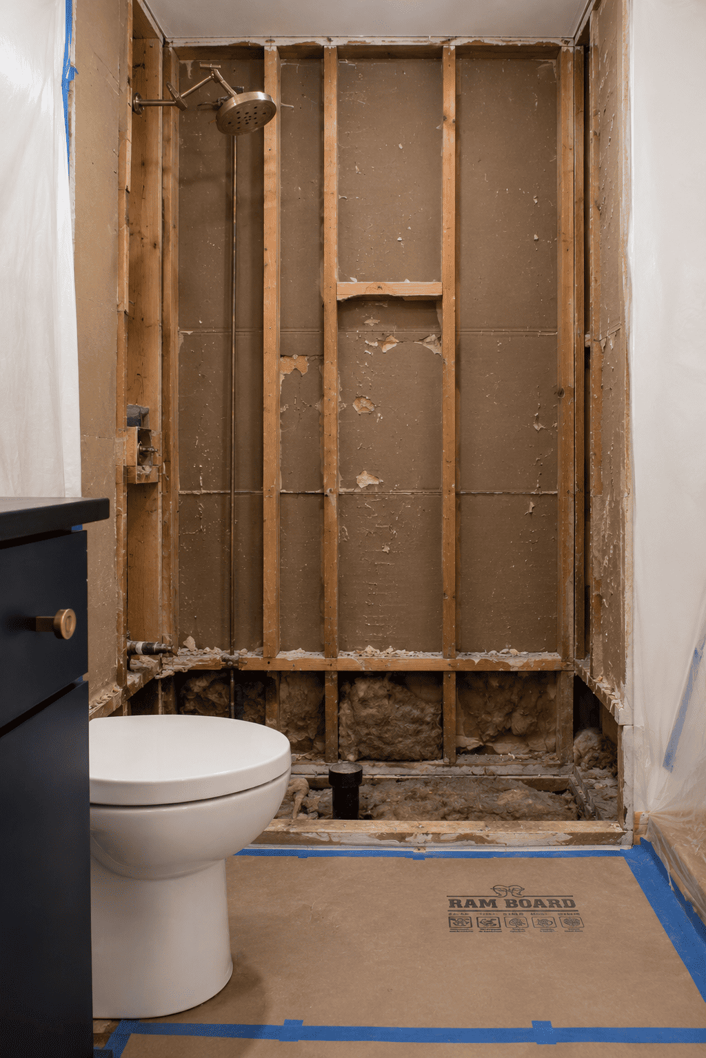 Protection and demolition phase of a tub-to-shower conversion in Toronto