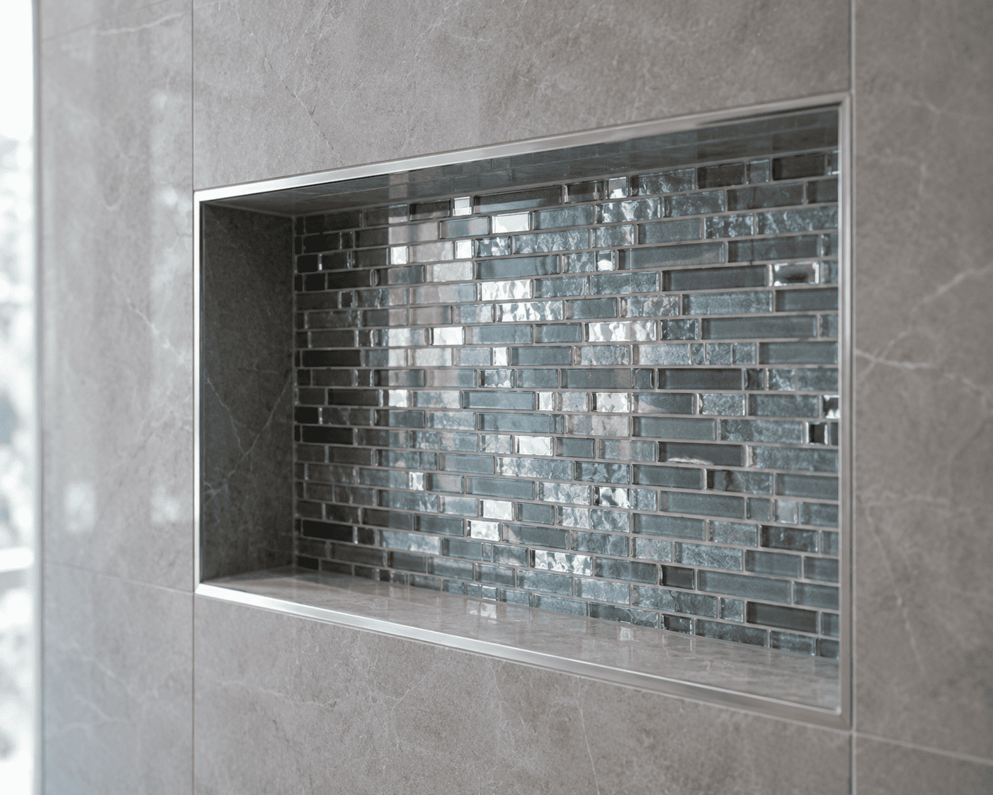 Glass mosaic shower niche accent tile in a Toronto bathroom